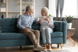 happy couple enjoying air conditioning at home